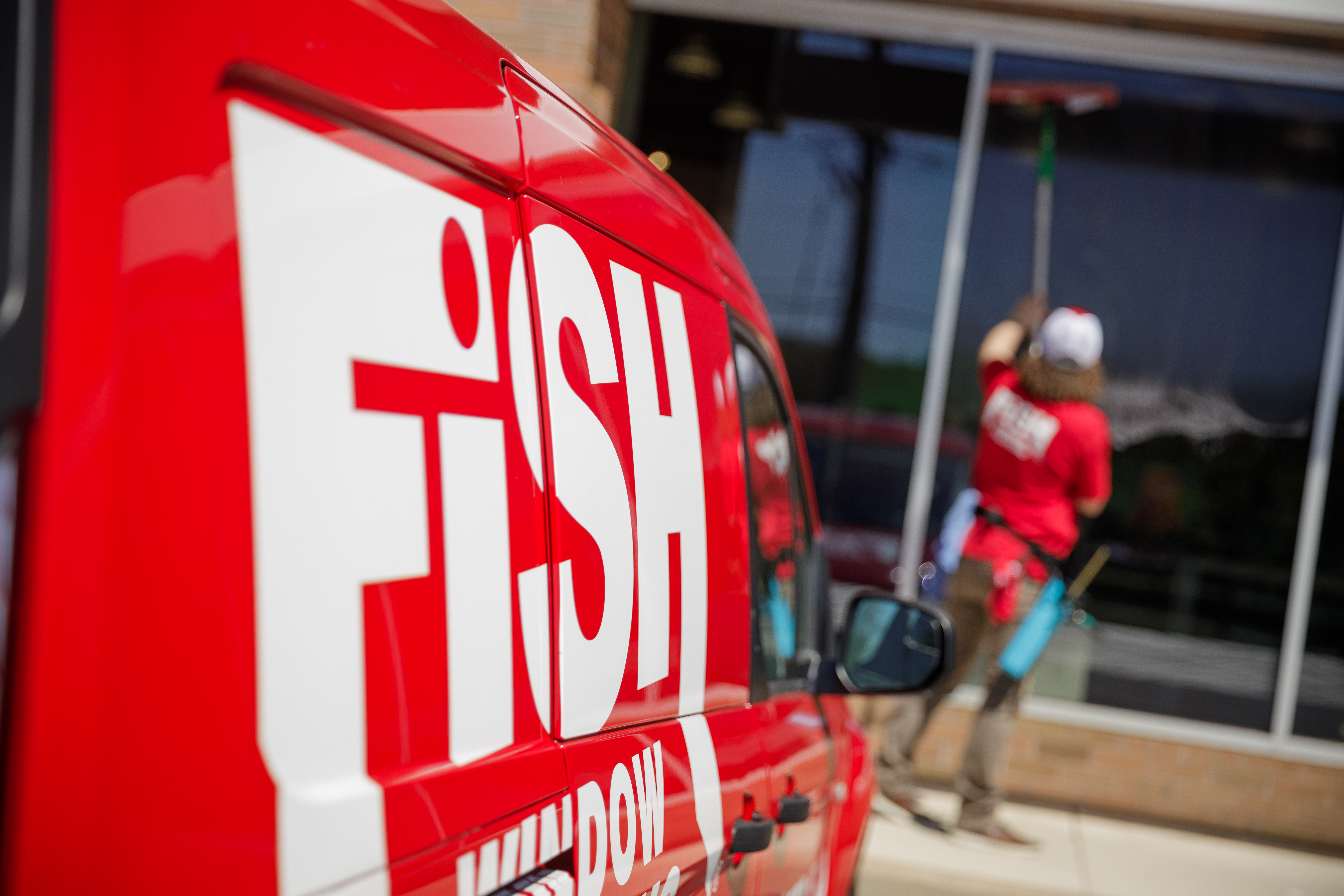 Fish Window Cleaning Van and Cleaner Cleaning Storefont Windows